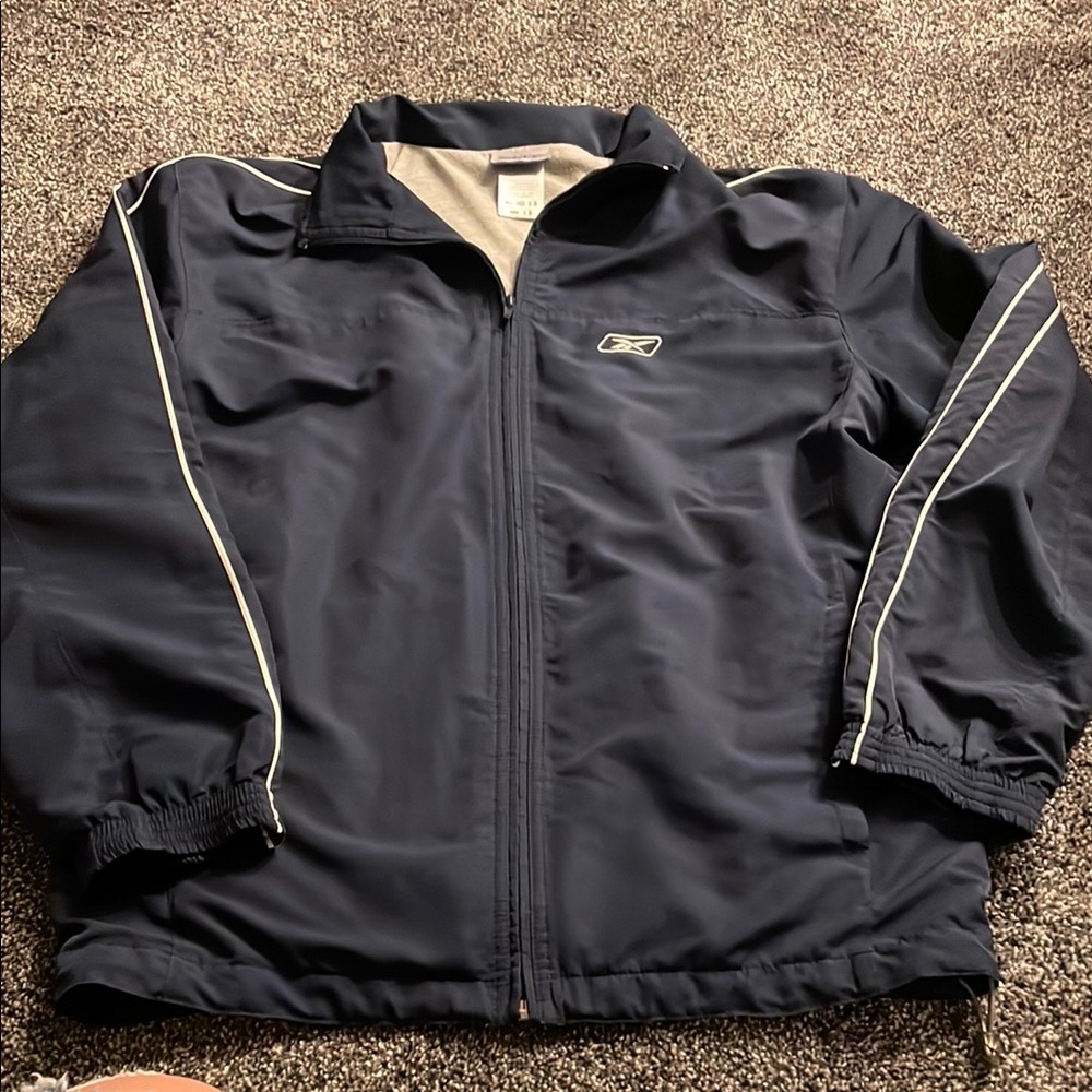 Navy Reebok track jacket.